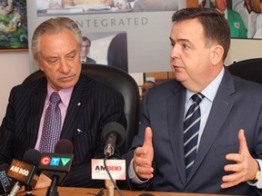 Paul Godfrey (L), chair of the board of directors for the Ontario Lottery and Gaming Corporation (OLG) and Ontario finance minister Dwight Duncan (R) address media in Windsor, Ont. on March 14, 2012.