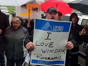 Supporters of Windsor's horse racing industry protest outside Ontario Finance Minister Dwight Duncan's constituency office on Mar. 30, 2012.