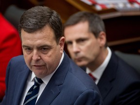 Ontario Finance Minister Dwight Duncan announces the 2012 provincial budget. Premier Dalton McGuinty looks on.