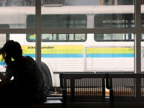 A woman waits for a Transit Windsor bus at the downtown station in Windsor, Ont. on March 23, 2012.