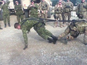 Windsor reservist John Celestino (L) struggles to win a tug of war with a U.S. National Guard member in this screen grab from a viral video.