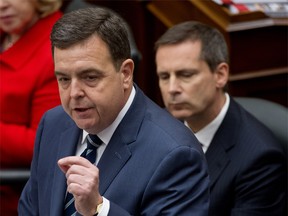 Ontario Finance Minister Dwight Duncan gestures as he delivers the 2012 provincial budget. Premier Dalton McGuinty (R) looks on.