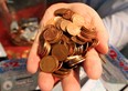 A handful of pennies. (Nick Brancaccio / The Windsor Star)