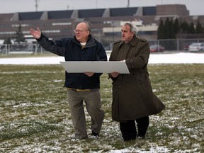 Ron Schlegel (L), chairman of Schlegel Villages, and St. Clair College president John Strasser (R) look over the proposed site of a long-term care facility in this December 2011 file photo. (Nick Brancaccio / The Windsor Star)