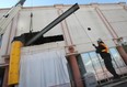 Workers move a large piece of steel into place Tuesday, April 17, 2012, in Windsor, Ont. at the former Palace Theatre on Ouellette Ave., the future home of the Windsor Star. The steel will be used to build up the floors in the building. (DAN JANISSE/The Windsor Star)