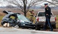Sgt. Phil Ouellette, right, from the Ontario Provincial Police, investigates the scene of a two-car motor vehicle collision involving a Honda Acura and a Chevy pick-up at the intersection of Walker Road and South Talbot Road in Tecumseh, Saturday, Dec. 31, 2011. (Photo By: Dax Melmer)
