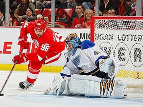 Tomas Holmstrom #96 of the Detroit Red Wings attempts a wrap around on Jaroslav Halak #41 of the St. Louis Blues during their NHL game at Joe Louis Arena on January 23, 2012 in Detroit, Michigan. (Photo by Dave Sandford/Getty Images)