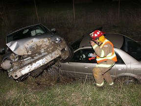 A firefighter on the scene of an E.C. Row collision on Wednesday, April 4, 2012. (Photo By: Dan Janisse)
