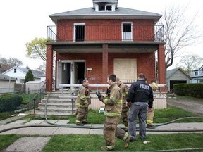 Windsor firefighters clean up after a suspected arson fire broke out for the second time in three days at a house on the 800 block of Pillette Road, Sunday, April 1, 2012. (DAX MELMER/The Windsor Star)