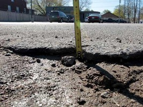 A hole is visible on Seminole Road in Windsor, Ont. on Wednesday, April 4, 2012, during the launch of the "worst roads" campaign by the Canadian Automobile Association. The public is encouraged to vote online at WorstRoads.ca. (JASON KRYK/The Windsor Star).