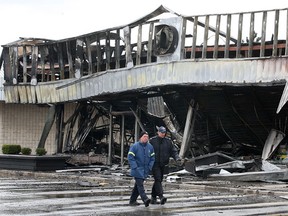 WINDSOR, ONT. April 10, 2012.:  Fire officials check out the aftermath of a massive blaze Tuesday, April 10, 2012, at an east Windsor, Ont. plaza. The fire, which broke out about 8:15 p.m. Monday in the Dollarama store in the East Park Centre on Tecumseh Road East, damaged several nearby businesses and caused damages in excess of $1 Million.  (DAN JANISSE/The Windsor Star)