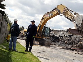 WINDSOR, ON.: APRIL 11, 2012 -- Fire investigators sift through the remains of the Dollarama on Tecumseh Road East in Windsor on Wednesday, April 11, 2012. (TYLER BROWNBRIDGE / The Windsor Star)