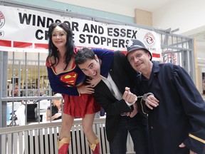 Ward 10 city councillor Al Maghnieh (centre) is hauled off at the 2011 Bail or Jail event at the Devonshire Mall. Volunteers Kim Klyn (L) and Joe Howe (R) conduct the arrest. (Jason Kryk / The Windsor Star)