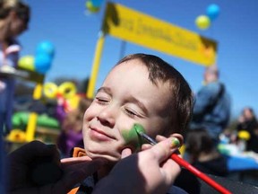 Kingston Gardin, 3, has his face painted by Skittles the Clown while at a fundraising event for the Alex's Lemonade Stand Foundation for childhood cancer research in the Sobey's parking lot in Amherstburg, Friday, April 6, 2012. (DAX MELMER/The Windsor Star).