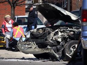 Paramedics treat a woman at the scene of a two-vehicle collision at the intersection of Ottawa Street and Kildare Road on April 2, 2012.