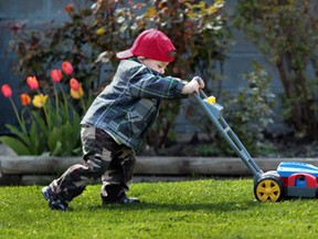 Zachary Vanvouwerff, 2, pushes a toy lawnmower along Howard Avenue in Windsor, Ont. on April 9, 2012. (Jason Kryk, The Windsor Star)