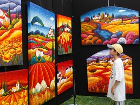 Young Jacob Rothera takes in some colour during the 2008 edition of Art in the Park at Willistead Park in Windsor, Ont. (Pawel Dwulit / The Windsor Star)