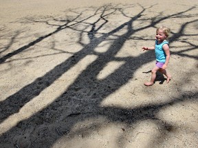In this recent file photo, Leah Whittal, 3, of Windsor, Ont. runs in the leafless shadow of a tree Thursday, May 3, 2012, at the Sand Point Beach. (Dan Janisse/The Windsor Star)