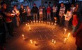 Friends and family hold a candle light vigil in front of the home of Richard Lemmon in Windsor on Wednesday, May 16, 2012. Lemmon was found dead at his residence on Tuesday Morning. (TYLER BROWNBRIDGE / The Windsor Star)