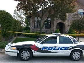 A Windsor police cruiser and crime tape surround a scene in the 2700 block of Jacob Avenue where a 22-year-old man was "acting strangely" on May 3, 2012. When found by an officer, the man was having breathing difficulties. He was taken to hospital, where he was pronounced dead. (Nick Brancaccio / The Windsor Star)