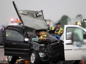 Emergency personnel work on the scene of a two-vehicle collision Tuesday, May 29, 2012, on the 401 east of highway 77.  (DAN JANISSE/The Windsor Star)