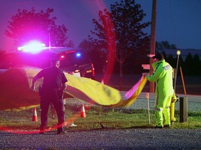 STONEY POINT, ON.: MAY 3, 2012 -- OPP officers investigate a hit and run accident on County Road 2 near Stoney Point on Thursday, May 3, 2012. A woman was transported to hospital with life-threatening injuries.        (TYLER BROWNBRIDGE / The Windsor Star)