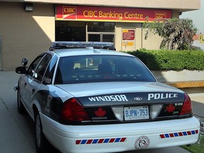 A Windsor police cruiser sits near the CIBC branch at 700 Tecumseh Road East, shortly after a robbery attempt on June 30, 2011. (Nick Brancaccio / The Windsor Star)