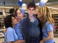 Downtown Shoppers Drug Mart employees Parveen Sawal (L), Olivia Parent (centre) and Lisa Palazzolo (R) pose with a life-size cardboard cutout of pop superstar Justin Bieber in Windsor, Ont. on May 11, 2012. The store is auctioning off the cutout for charity (Dan Janisse / The Windsor Star)