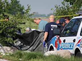 DETROIT, ONT.:MAY 20, 2012 -- Windsor Police inspect a body that was discovered in the Detroit River at Riverside Drive west and Caron Avenue, Sunday morning, May 20th, 2012.  (DAX MELMER/The Windsor Star)