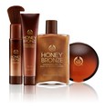 Products from the Body Shop's Summer Essentials Honey Bronze line are seen in this promotional image.