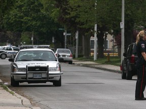 A Windsor police officer turns away traffic in the 1500 block of Hall Avenue as other officers investigate a bomb threat. Photographed May 1, 2012. (Dan Janisse / The Windsor Star)