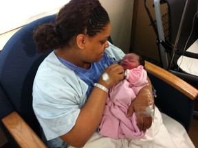 Windsor resident Shireen Anderson cradles her baby girl Azauria, who was born in a Tim Hortons washroom in WIndsor, Ont. on May 8, 2012. Photographed at Windsor Regional Hospital. (Trevor Wilhelm / The Windsor Star)