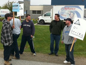 Striking workers picket Reliance Home Comfort at 1900 Blackacre Drive in Oldcastle, Ont. on May 2, 2012. (Nick Brancaccio / The Windsor Star)