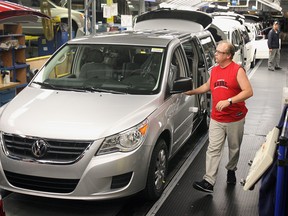 A line worker at Chrysler's Windsor Assembly Plant checks a newly-built Volkswagen Routan in this November 2008 file photo. (Nick Brancaccio / The Windsor Star)