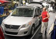 A line worker at Chrysler's Windsor Assembly Plant checks a newly-built Volkswagen Routan in this November 2008 file photo. (Nick Brancaccio / The Windsor Star)