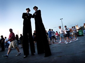 Windsor's Stilt Guys Kyle Sipkens (L) and Mark Lefebvre (R) pose at the opening of the 2007 Bluesfest in this file photo. (Tyler Brownbridge / The Windsor Star)