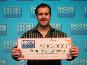 Windsor, Ont. lottery winner Scott Troup, 25, shows off the $100,000 cheque he won by playing Encore in the May 11, 2012 Lotto MAX draw. (Handout image / The Windsor Star)