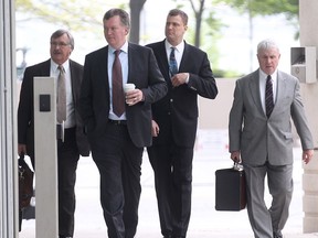 WINDSOR, ONT. MAY 2, 2012-  Windsor police Det. David Van Buskirk, second from right, enters the Ontario Court of Justice, Wednesday, May 2, 2012, in Windsor, Ont. with his legal representatives. He was being sentenced for the assault causing bodily harm charge for the beating of Dr. Tyceer Abouhassan. (DAN JANISSE/The Windsor Star)