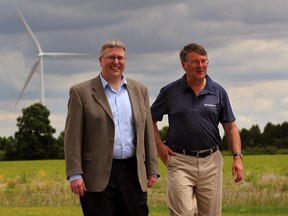 Ian Kerr (L) of Brookfield Renewable Power and Bill Lamb (R), a Brookfield site representative, walk about the wind farm in Lakeshore, Ont. on June 5, 2012. (Nick Brancaccio / The Windsor Star.)