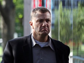 Former Windsor Police officer David Van Buskirk, right, walks toward Superior Court of Canada to be sentenced June 7, 2012.