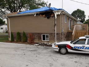 Windsor Police keep a close eye on a home at 2318 Meighen Road where a woman died early Sunday morning following a fire. Police had to assist a distraught woman who nearly collapsed at the scene as she visited Monday morning, June 11, 2012. (NICK BRANCACCIO/The Windsor Star)