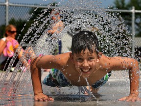 Brandon Campeau plays in the spray pad at the AKO Park in this file photo.