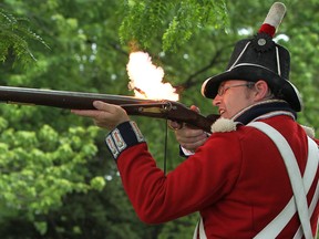 Bill Kovacs, dressed as a sgt. of the Royal Marines from 1812, fires his musket after the Noon Gun firing at King's Naval Yard Park in Amherstburg, Saturday, June 16, 2012. (DAX MELMER/The Windsor Star)