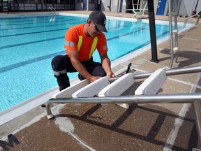 Paul Mazak of the City of Windsor repairs a broken ladder on the Lanspeary Park Pool Monday June 18, 2012. City pools will be used heavily with hot weather forecast for the next few days. (NICK BRANCACCIO/The Windsor Star)