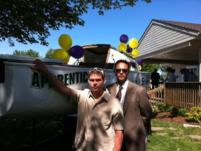 Apprentice Nathan Roles, left, and the Greater Essex County District School Board’s Doug Plumb are proud of the sailboat restored as part of the board’s co-operative education program. The sailboat, christened “The Apprentice,” was dedicated Thursday at the Cedar Island Yacht Club in Kingsville. (The Windsor Star / Sarah Sacheli)