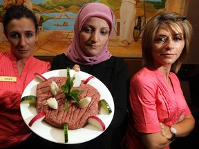 Waitress Enas Alkayal, left, Lina Abbas and Lina Tannous, all of El-Mayor Restaurant on Wyandotte Street East, display a plate of kibbeh which they cannot serve Monday June 25, 2012. (NICK BRANCACCIO/The Windsor Star)
