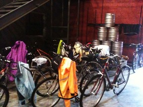 Bikes and dripping raincoats in front of kegs at the Walkerville Brewery.