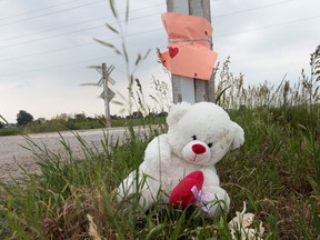 A stuffed toy and a note reading "Rest in Peace"  remain at the accident scene that claimed the lives of two Belle River children on Strong Road at the CP rail tracks in Lakeshore, Ontario. (JASON KRYK/  The Windsor Star)