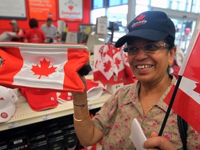 Windsor citizen Suryakumari Devarajulu picks out some Canada Day merchandise at the Canadian Tire store on Tecumseh Road West in Windsor, Ont. on June 29, 2012. (Nick Brancaccio / The Windsor Star)