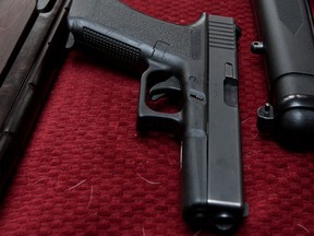 A Glock 17 pistol and other firearms are seen in this 2011 file photo. (Lars Hagberg / Postmedia News)
